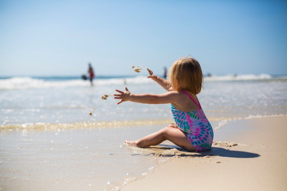 girl toddler playing in the beach