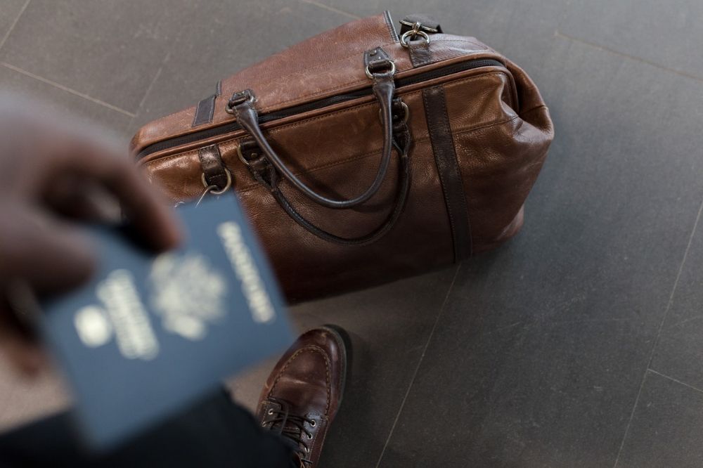 blurry shot of passport and traveling bag