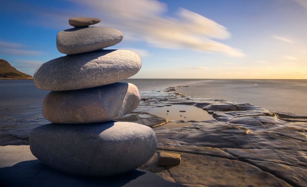 close up of stacks of rocks in the shoreline at sunset