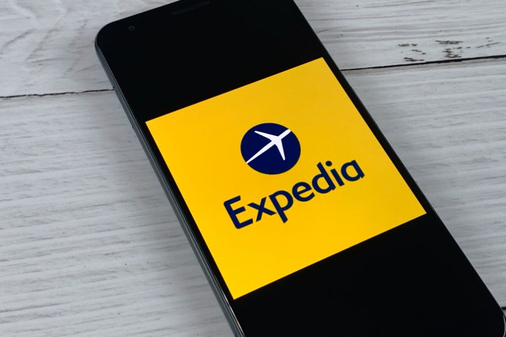 close up of the expedia logo is displayed on a phone